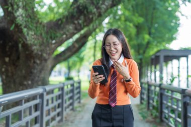 Students playing with mobile phones and laughing