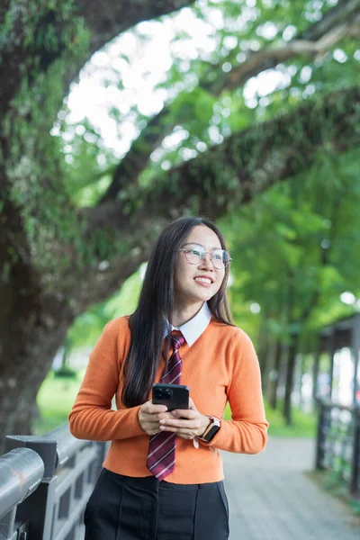 Students playing with mobile phones and laughing