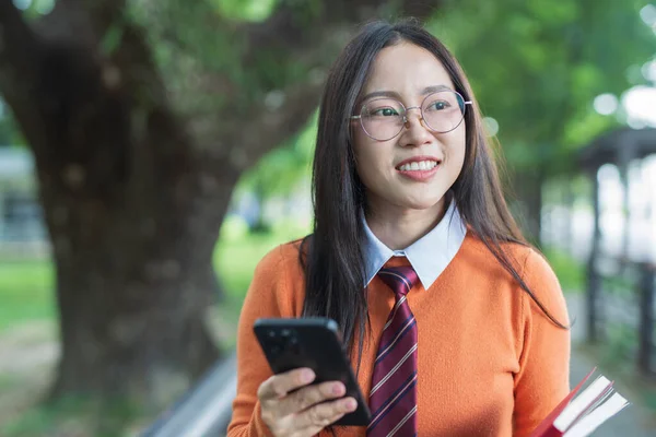 Students playing with mobile phones and laughing