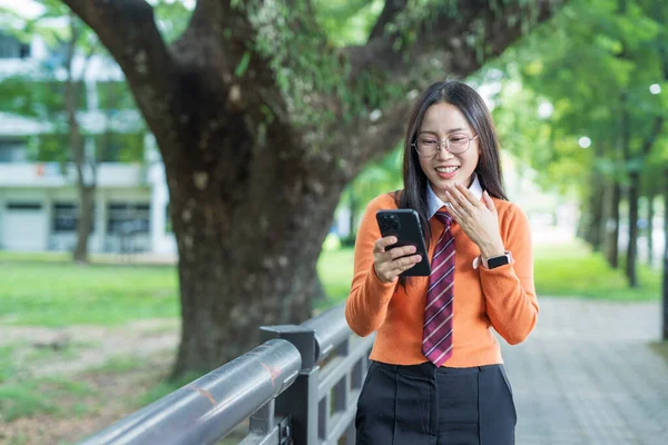 Students playing with mobile phones and laughing