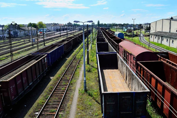Railway wagons with cargo on the tracks, railway infrastructure, rails, poles, traction.