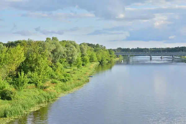 River meanders on a cloudy day, clouds in the sky. Summer.