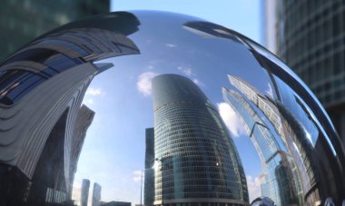 Reflection on a spherical surface of a group of skyscrapers made of glass and concrete, gray-blue, steel color gamut, modern architecture, distortion clipart