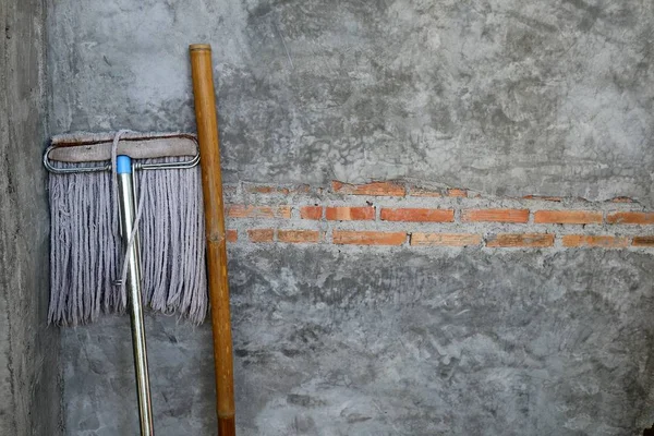 Vintage concrete wall and mop cleaning equipment