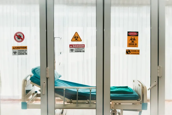 Patient room and bed for patients in the hospital\'s coronavirus (covid-19) epidemic containment room. Glass room that can treat and stop the spread of the disease and medical
