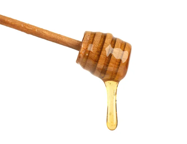 Fresh honey dripping from a honey dipper isolated on white background, bee products by organic natural ingredients concept — Stock Photo, Image