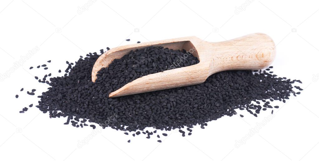 Black cumin seeds in wooden spoon, isolated on white background. Nigella sativa.