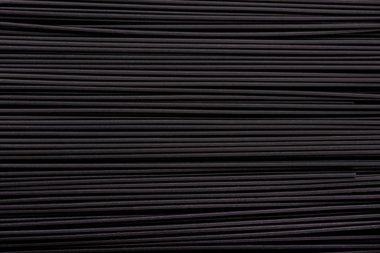 Siyah makarna arka plan. Kalamar müreklü siyah spagetti, arka plan. Siyah mürekkep balığı mürekkesi ile makarna.