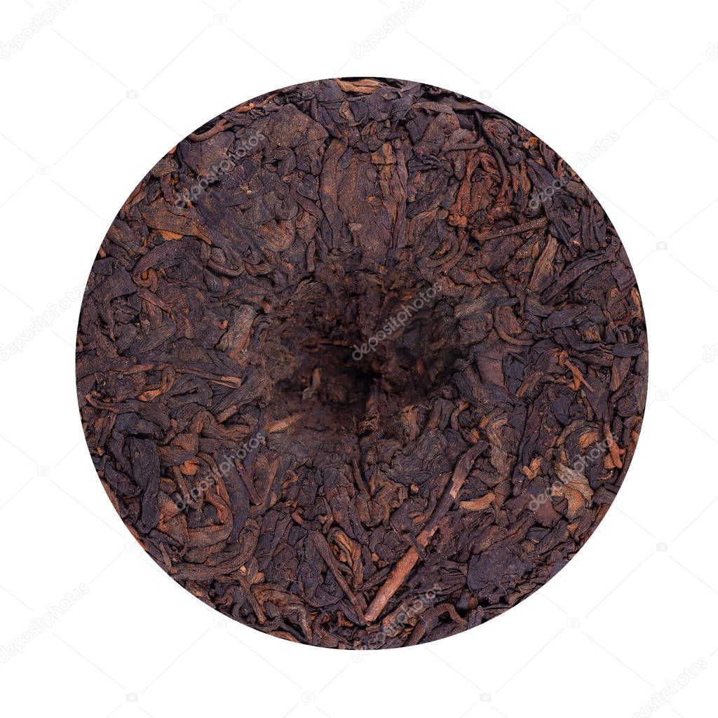 Round flat disc of puer tea isolated on white background. Chinese tea Shou Puer. Pressed fermented Pu-erh tea. Macro close up. Aromatic black puer tea. Healthy drink.