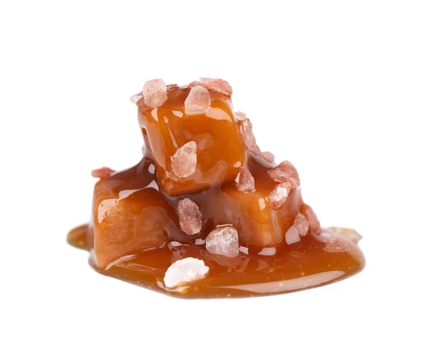 Salted caramel candies and sauce, isolated on white background. Delicious caramel. — Stock Photo, Image