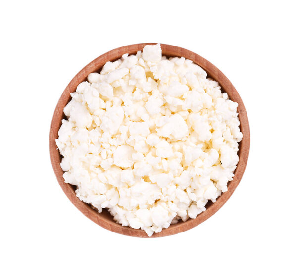 Cottage cheese in a wooden bowl isolated on a white background. Top view.