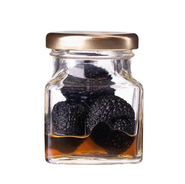 Canned black truffle isolated on a white background. Delicacy exclusive truffle mushroom. Piquant and fragrant French delicacy. Clipping path. — Stock Photo, Image