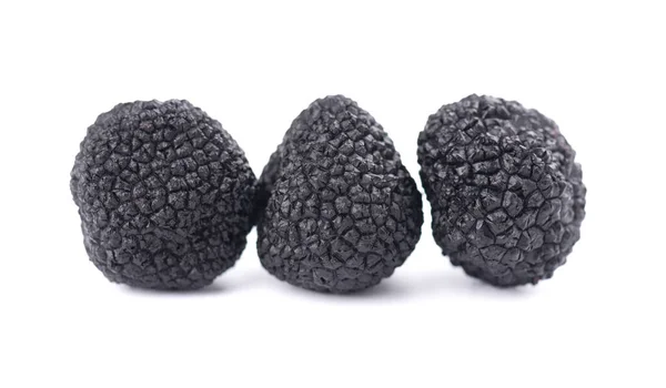 Black truffles isolated on a white background. Delicacy exclusive truffle mushroom. Piquant and fragrant French delicacy. Clipping path. — Stock Photo, Image