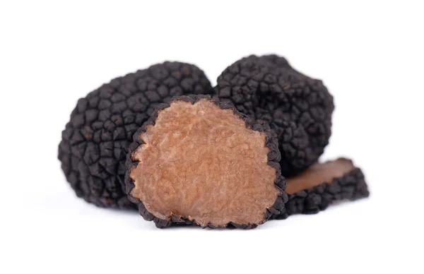 Black truffles isolated on a white background. Fresh sliced truffle. Delicacy exclusive truffle mushroom. Piquant and fragrant French delicacy. Clipping path. — Stock Photo, Image