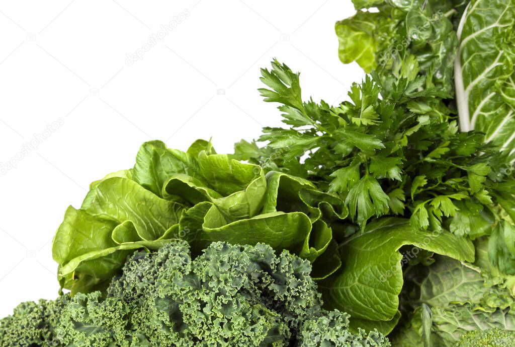 Clean salad and vegetable leaves on a white background