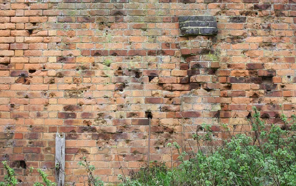 Bullet holes in a WW2 firing range brick wall