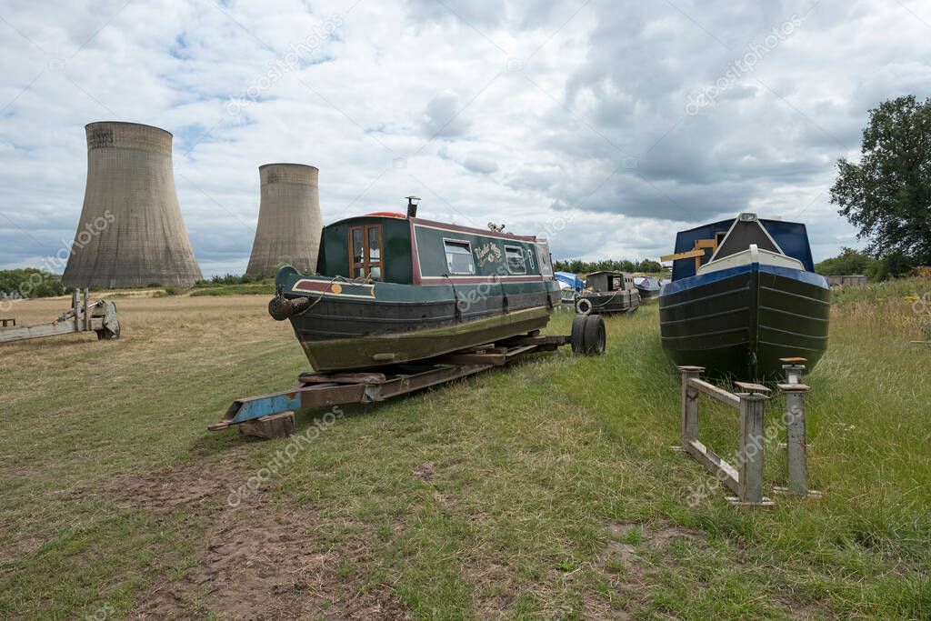 Old narrow boats in a field