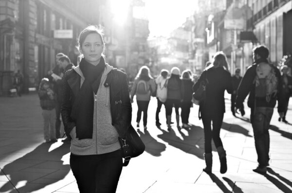 Woman walking towards the camera on a city street