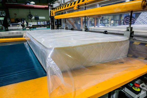 Ortopedik yatak vakumlama makinesi, bir yatağın vakumlanması, Güney Kore 'deki bir mobilya fabrikasında ortopedik yatak üretimi.