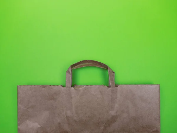 Eco friendly bag for products on a green background. Pure nature.