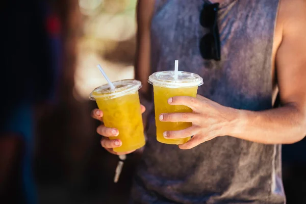 stock image Man is holding sugar cane juice in hands.