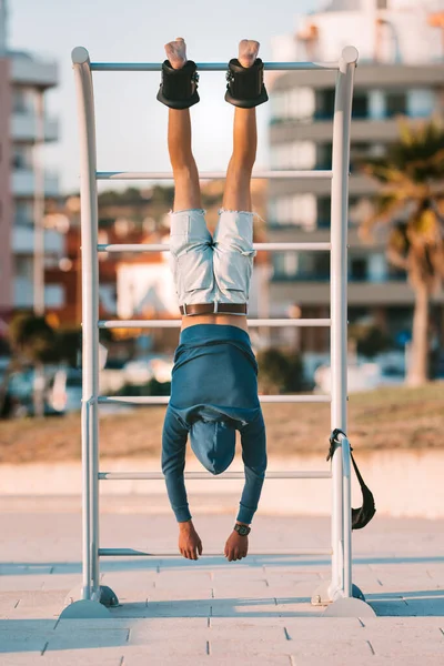 Man hanging upside down on the horizontal bar in anti gravity or inversion boots. Sports equipment.Boots help to reduce back pain, muscle tightness and spasms.To stretch neck and back.Align the spine — Stock Image Man hanging upside down on the horizontal bar in anti gravity or inversion boots. Sports equipment.Boots help to reduce back pain, muscle tightness and spasms.To stretch neck and back.Align the spine Royalty Free Stock Images