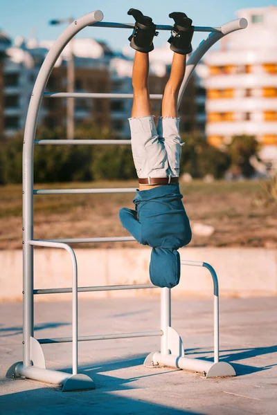 Man hanging upside down on the horizontal bar in anti gravity or inversion boots. Sports equipment. Boots help to align the spine — Stock Image Man hanging upside down on the horizontal bar in anti gravity or inversion boots. Sports equipment. Boots help to align the spine Stock Picture