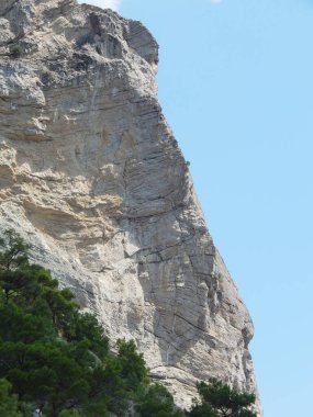 Uzamış, büyük kaya ve güneşli gökyüzü