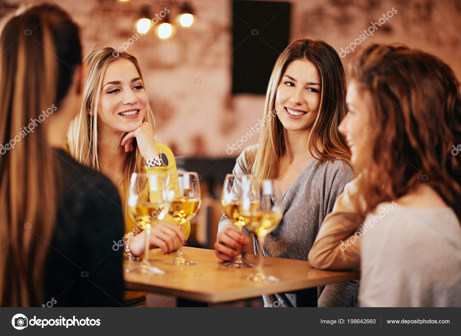 Female Friends Drinking Wine Chatting While Sitting Bar Stock Photo by