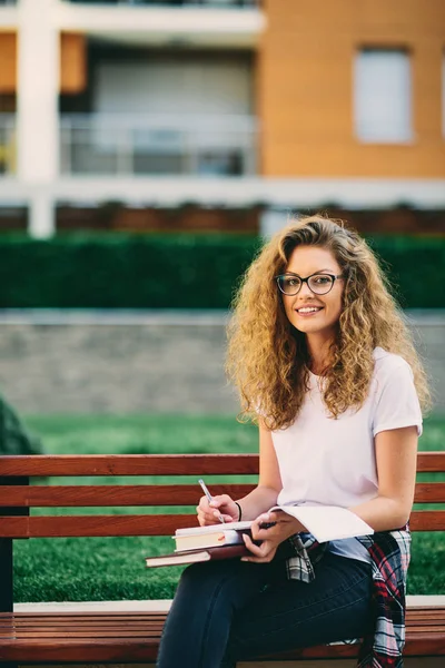 Esej Piśmie Kobiet Student Siedząc Ławce Kampusie — Zdjęcie stockowe