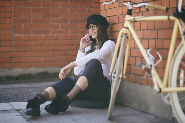 Mujer Sentada Acera Usando Teléfono Inteligente Junto Bicicleta Amarilla —  Fotos de Stock