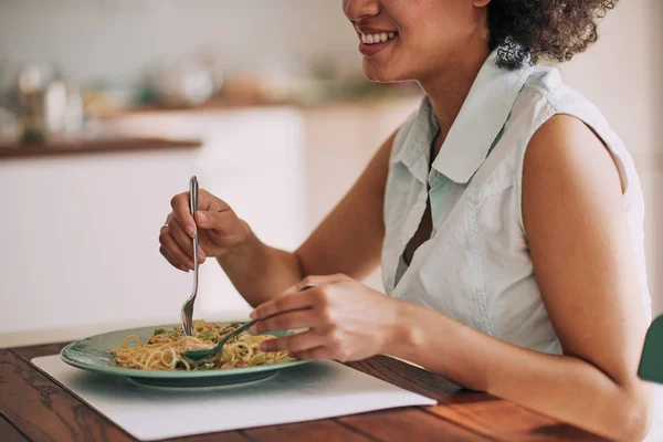 Beautiful Mixed Race Woman Eating Pasta Dinner While Sitting Kitchen — Stock Photo, Image
