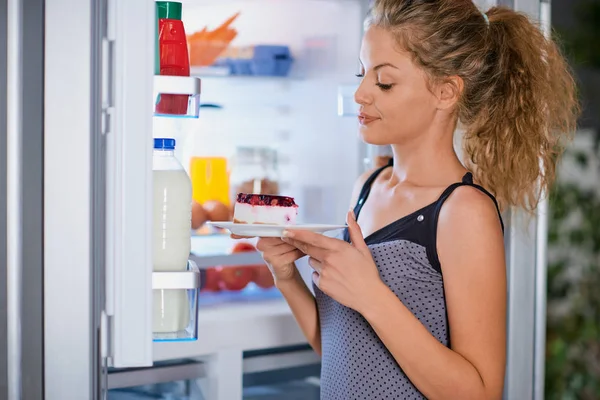 Woman Breaking Diet Taking Cheesecake Fridge Fridge Full Groceries — Stock Photo, Image