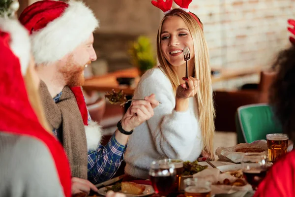 Friends having dinner for Christmas eve at home. Christmas holidays concept.