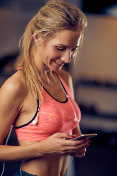 Mujer Usando Teléfono Inteligente Mientras Está Pie Gimnasio Cinta Correr — Foto de Stock