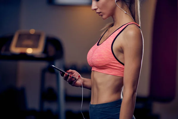 Woman Using Smart Phone While Standing Gym Background Treadmill Healthy — Stock Photo, Image