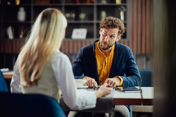 Two young attractive colleagues sitting in cafetaria and talking about project. — Stock Photo, Image