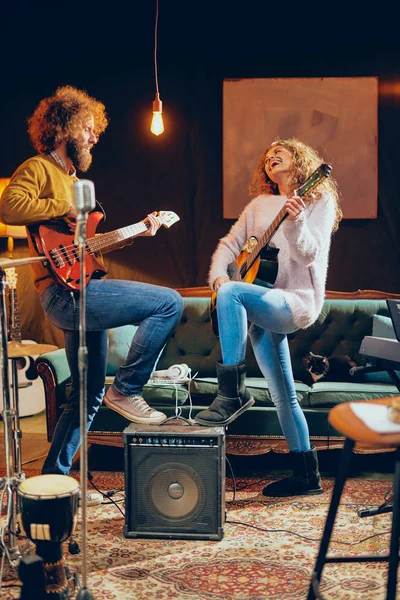 Akustik gitar bas çalmaya adam beyaz kadın. Ev stüdyosu iç.