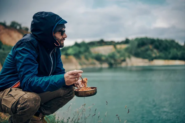 Joven Hombre Barbudo Atractivo Agachándose Junto Lago Disfrutando Vista Almorzando — Foto de Stock