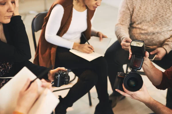 참석자들은 사진술 스튜디오에 앉아서 카메라 부품에 이야기하는 교사의 듣는다 — 스톡 사진