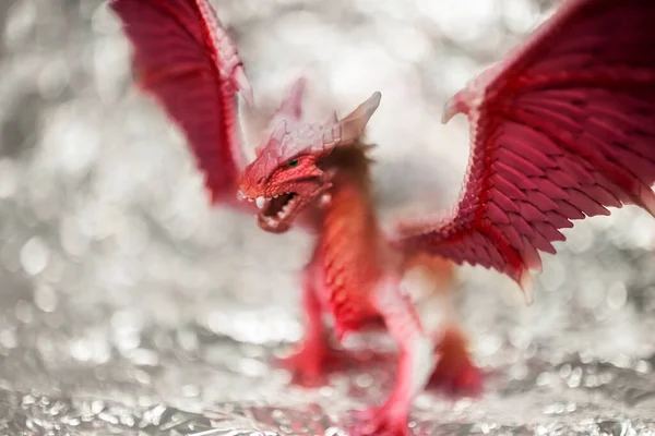Fire red dragon toy photo on blur bokeh background