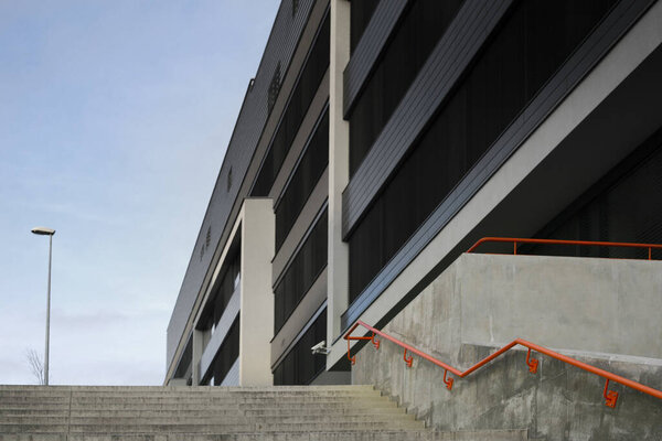 Cement concrete staircase with red railing in modern empty city