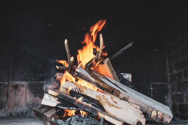 bonfire with wooden planks and fire to cook.