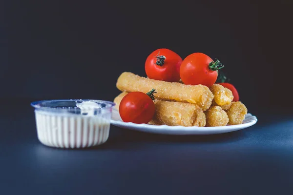 Delicious mozzarella cheese sticks with sauce. Cheese sticks with tomato.