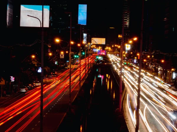 Traffic city at night, cars on the street with long exposure light  traces from car