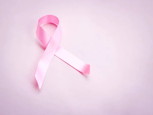 Breast cancer awareness pink ribbon on pink background, october symbol, healthcare and  medicine concept