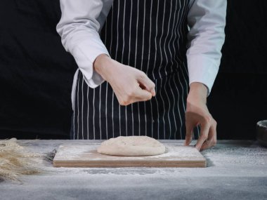Ellerin ekmek hamuru hazırlıyor, hamuru yoğuruyor. Un sıçramalı eller, ev yapımı fırın konsepti.