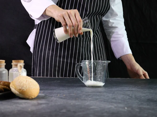 Bakery Man Pouring Milk Measuring Jug Kitchen Home Preparing Bread — Stock Photo, Image