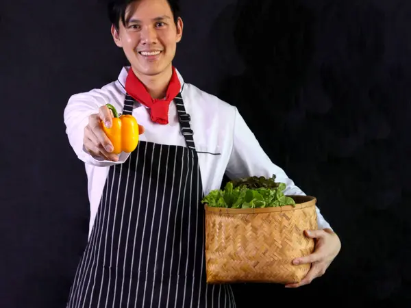 Young Asian Chef Wearing Apron Holding Yellow Bell Pepper Fresh — Stock Photo, Image