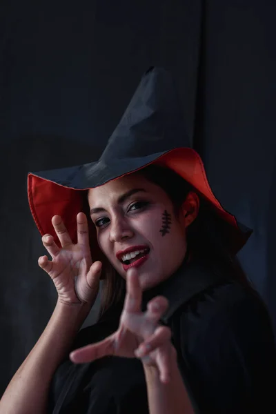 Halloween witch woman portrait, Fashion young woman going to party with spooky costume, makeup scary faces, having fun at Halloween party by celebration